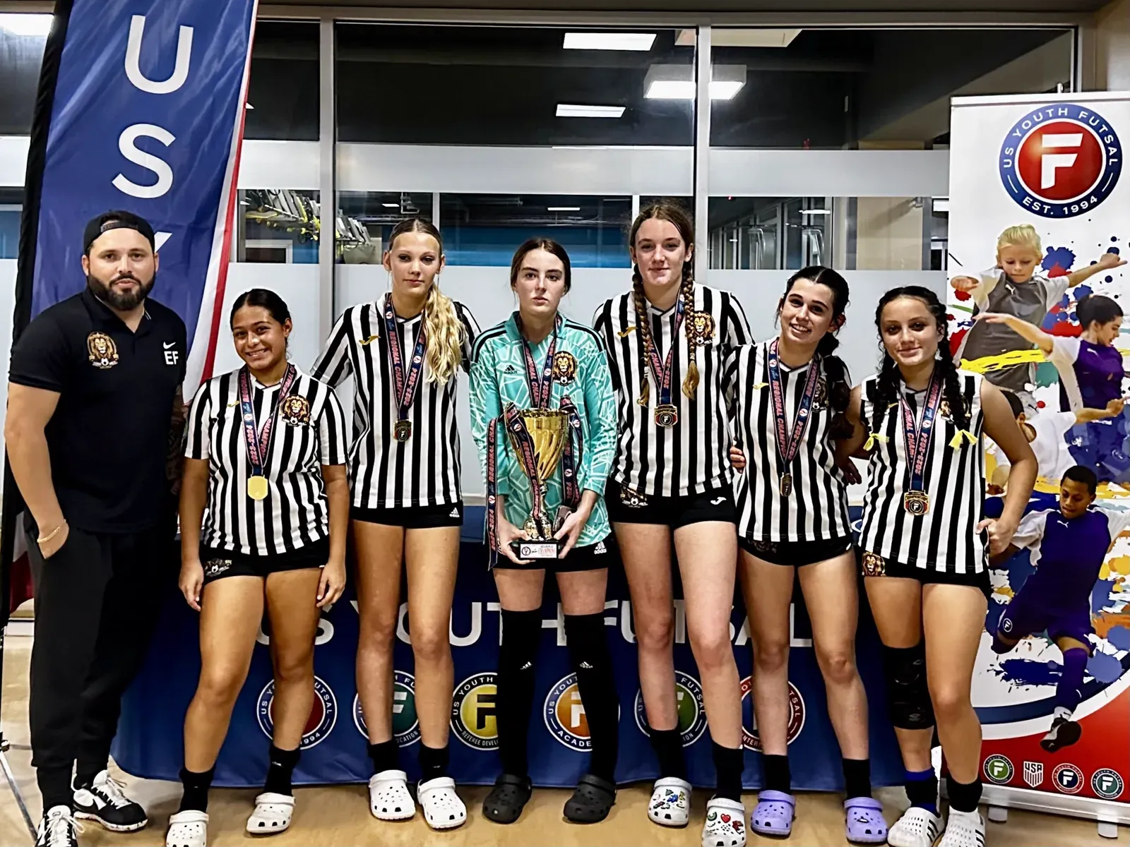 Lions players with medals and the trophy at US Youth Futsal regionals